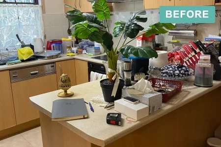 Kitchen bench crowded with items before a deceased estate clearance by Declutter Assistance